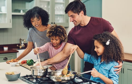 Family cooking on kitchen appliances with Tend home essentials protection.